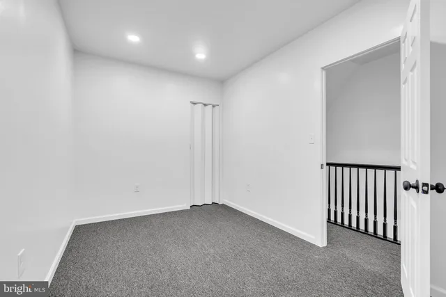 a bedroom with a bed and painting on the wall