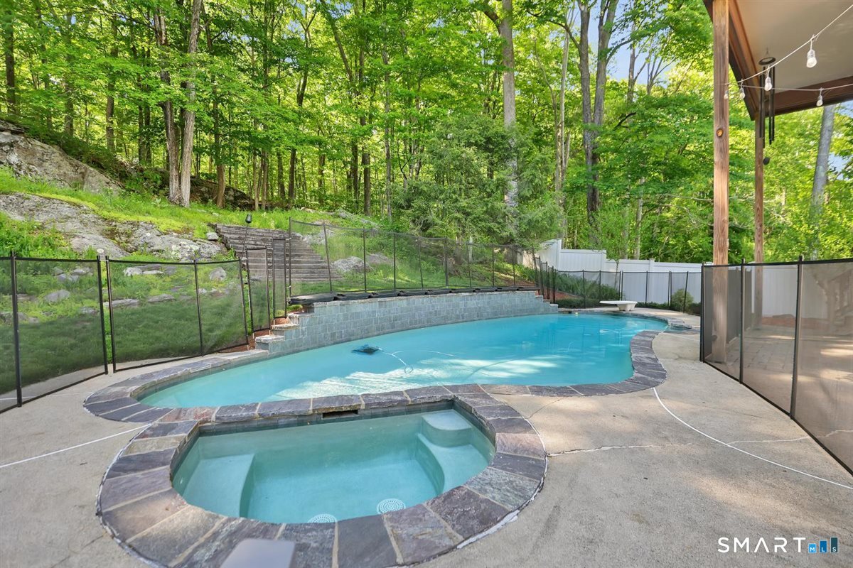 122 Ridgeview Circle Guilford, CT 06437 - Photo 29 of 40 Heated gunite pool and spa with Pebble Tec finish provide the perfect setting for summertime fun, morning exercise, or relaxed poolside lounging. NOTE: removable safety fence