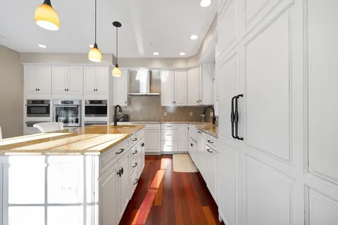 a large kitchen with stainless steel appliances a lot of counter space and a sink