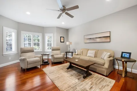 a living room with furniture and a wooden floor
