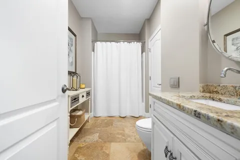 a bathroom with a sink a toilet and a shower