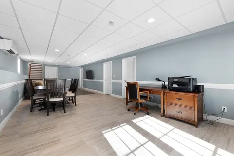 a view of a workspace with furniture and a workspace