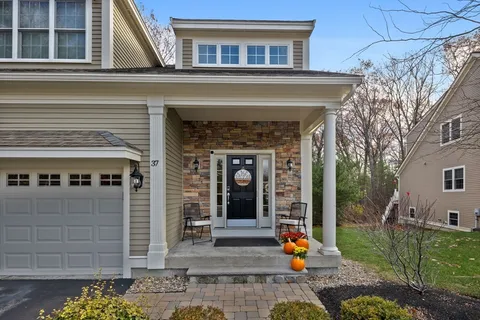 a front view of a house with large windows