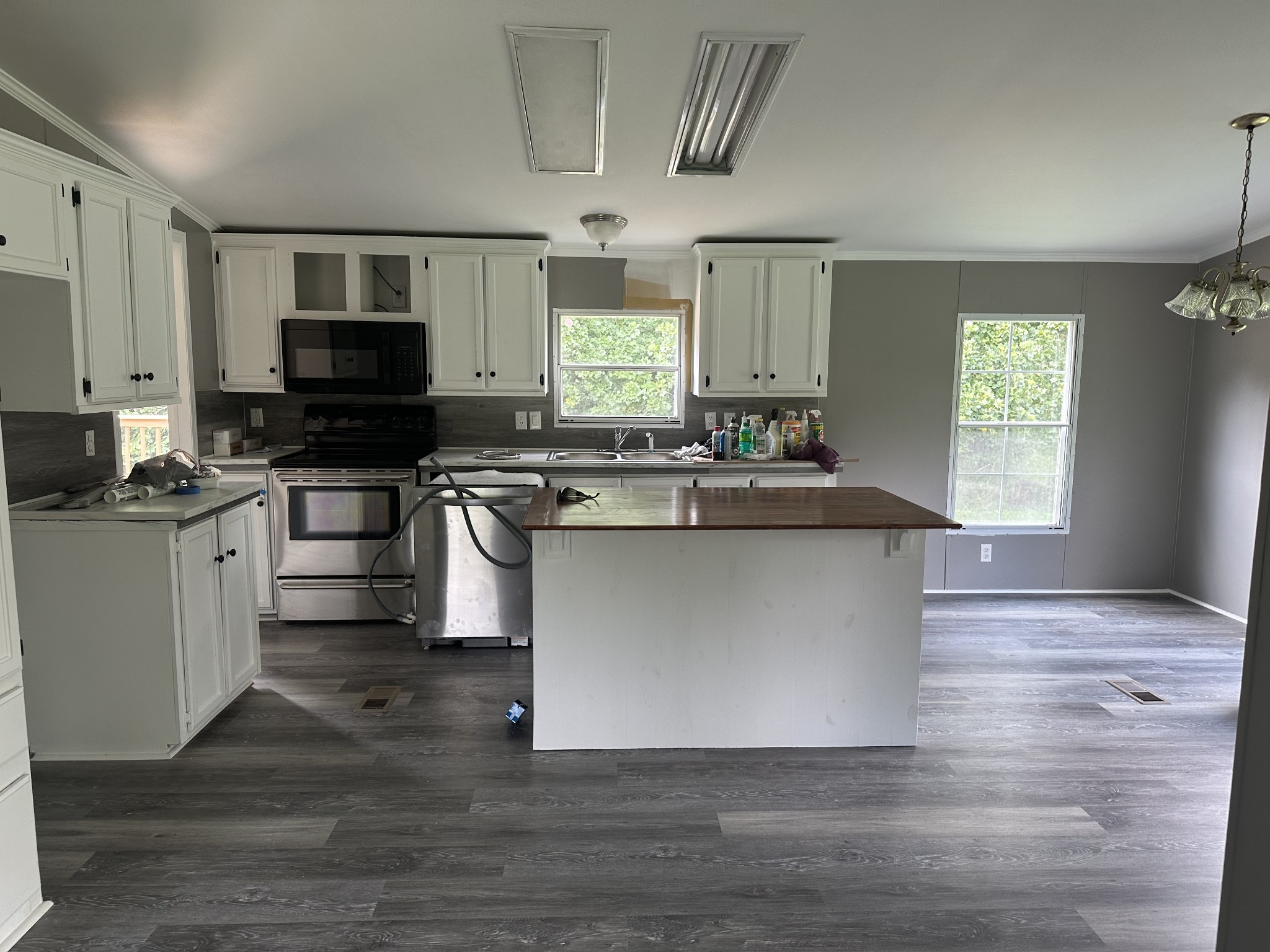 6409 Roy Pearson Road Springfield, TN 37172 - Photo 11 of 22 a kitchen with stainless steel appliances granite countertop a stove a sink and a microwave