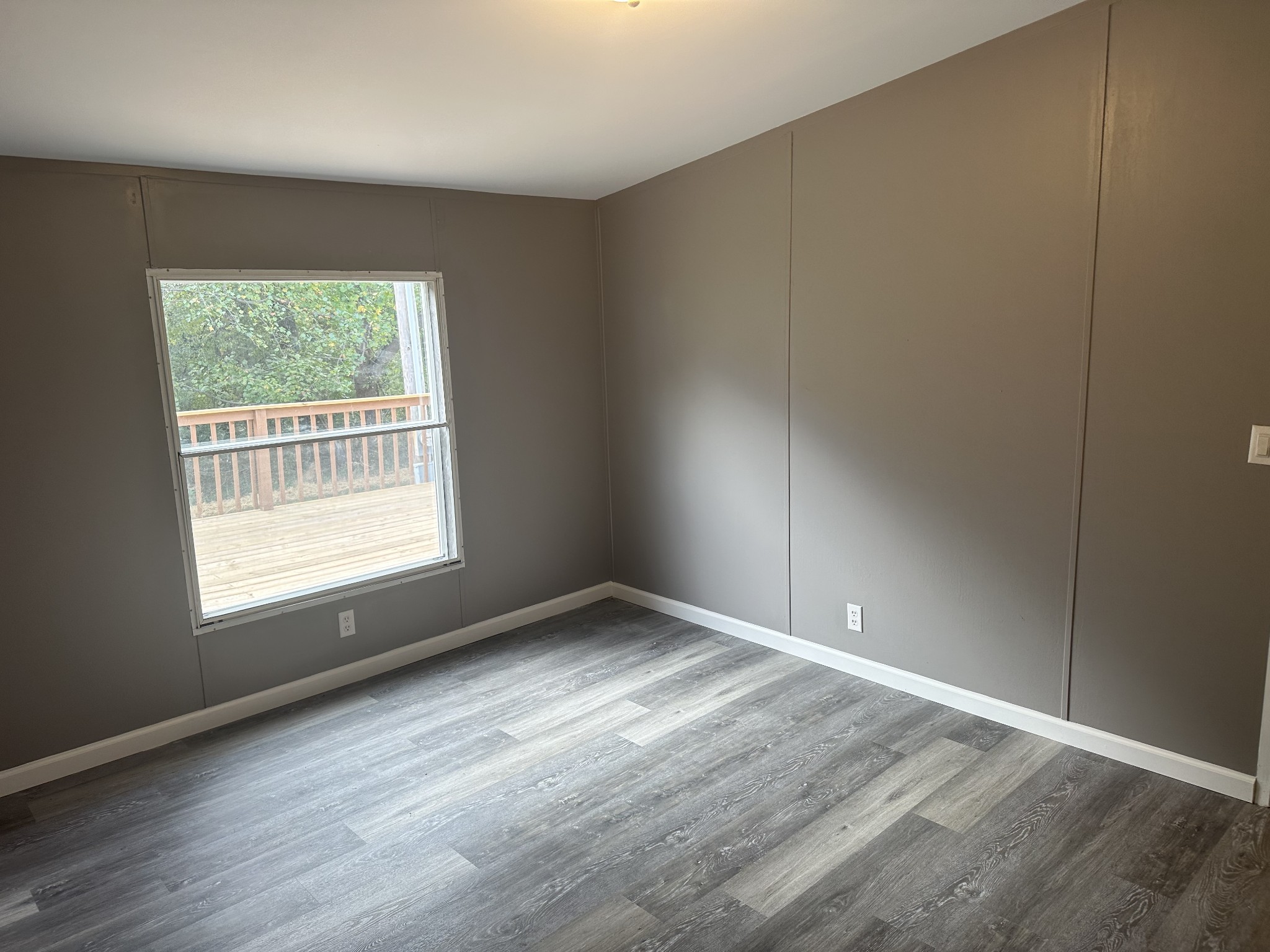 6409 Roy Pearson Road Springfield, TN 37172 - Photo 13 of 22 an empty room with wooden floor and windows