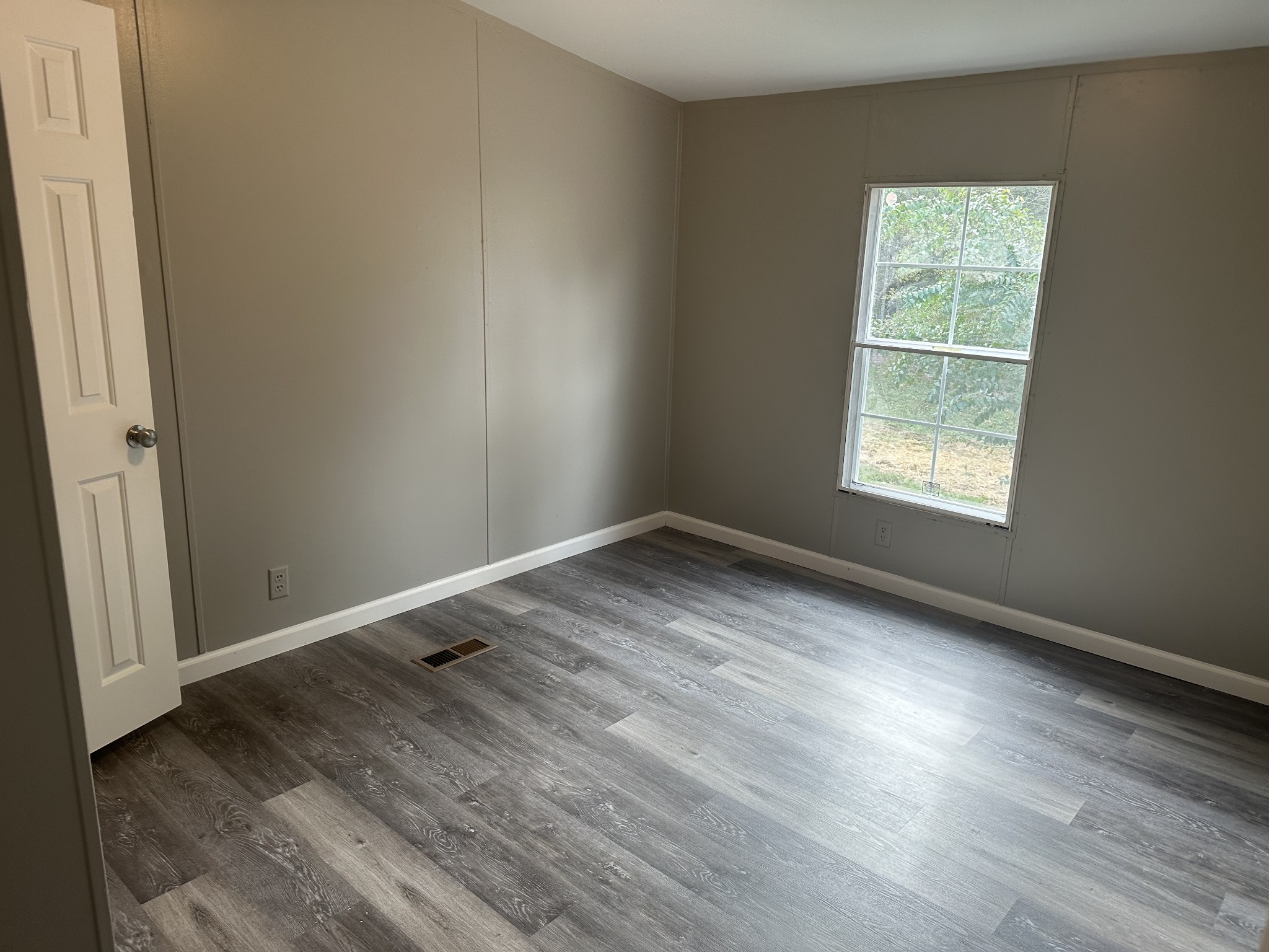 6409 Roy Pearson Road Springfield, TN 37172 - Photo 16 of 22 an empty room with wooden floor and windows