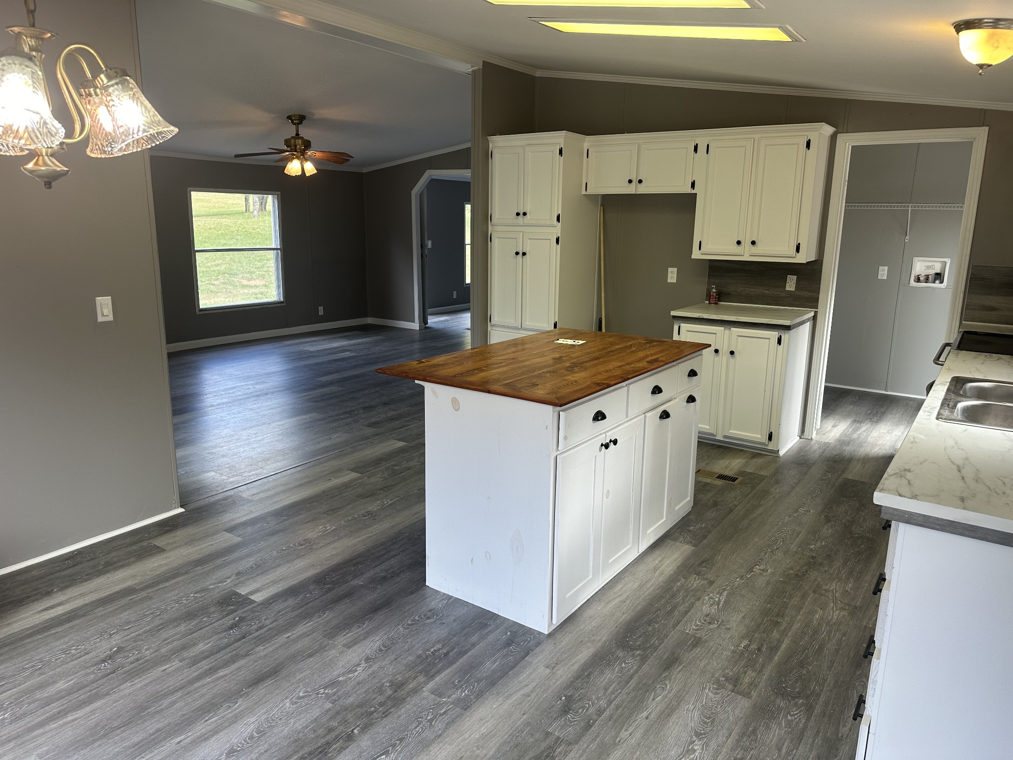 6409 Roy Pearson Road Springfield, TN 37172 - Photo 8 of 22 a kitchen with granite countertop a stove and a wooden floors