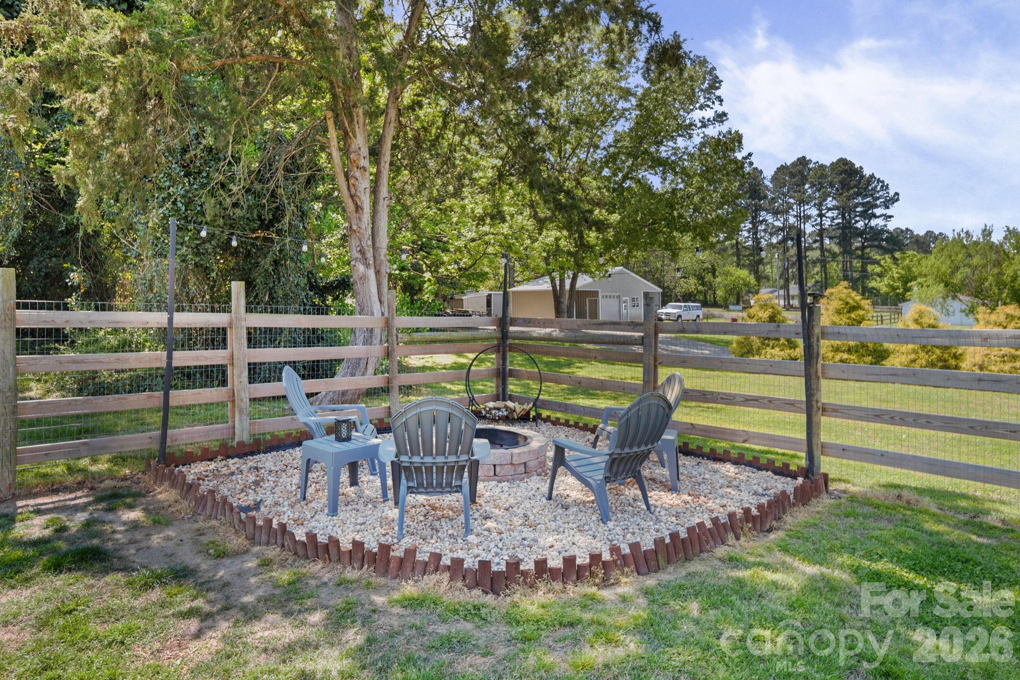 9215 Stokes Ferry Road Salisbury, NC 28146 - Photo 19 of 22 a view of a two chair and table in the garden