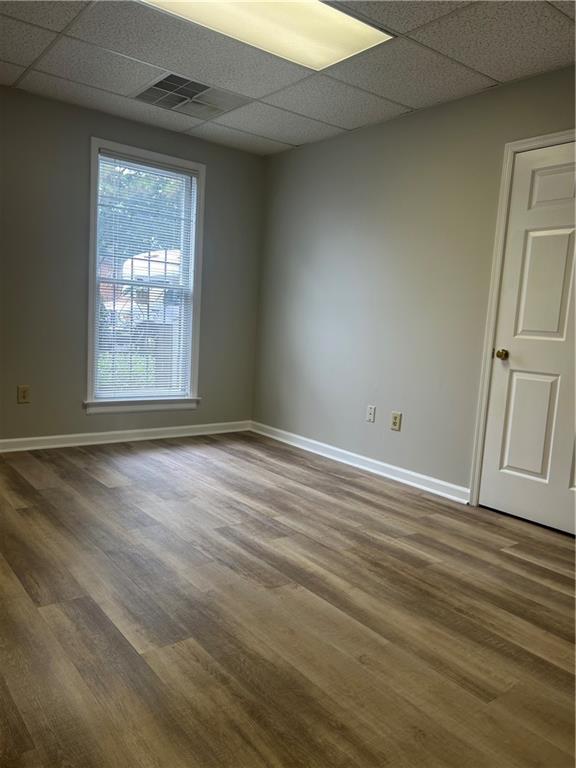 2623 Sandy Plains Road, Unit 101 Marietta, GA 30066 - Photo 2 of 6 an empty room with wooden floor and windows