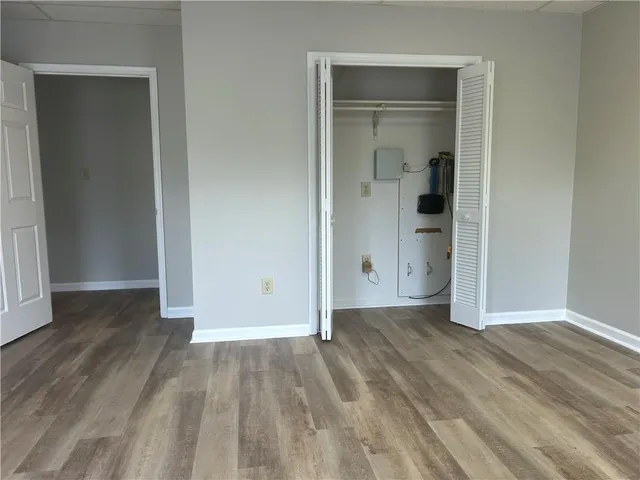 an empty room with wooden floor and closet
