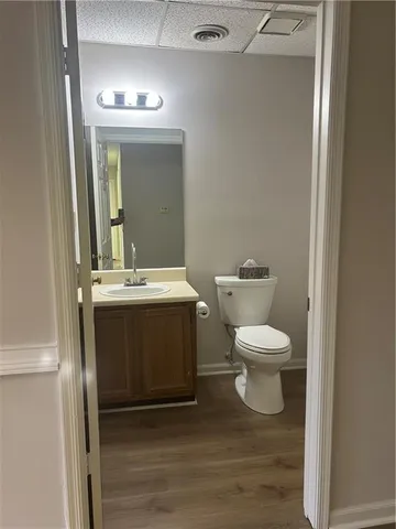 a bathroom with a toilet a sink and mirror