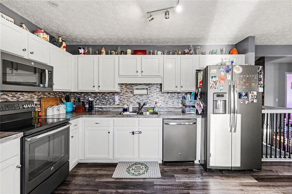302 Fairview Lane Dallas, GA 30157 - Photo 11 of 26 a kitchen with stainless steel appliances granite countertop a refrigerator sink and stove