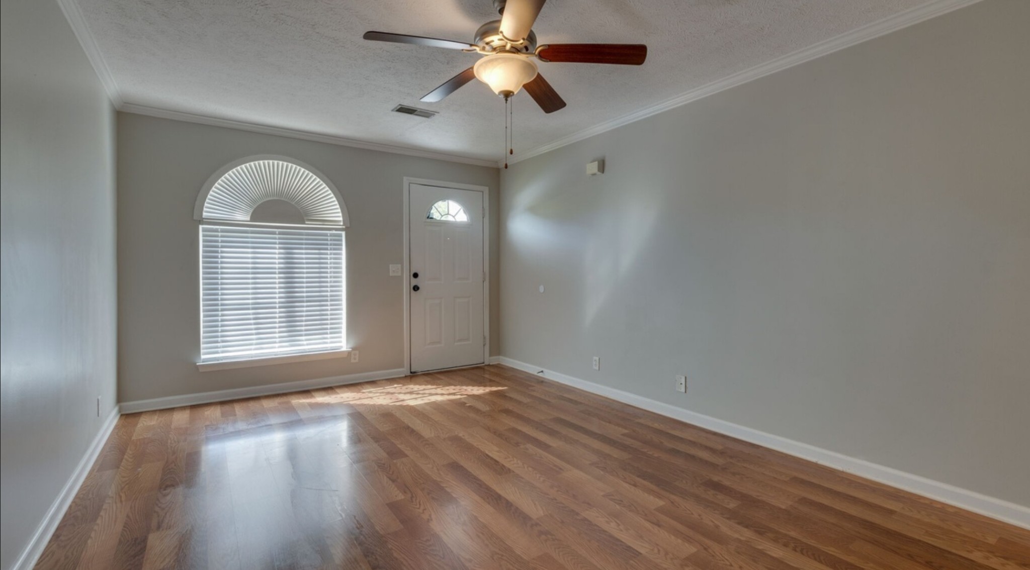 3001 Hamilton Church Road, Unit 403 Antioch, TN 37013 - Photo 6 of 21 an empty room with wooden floor chandelier fan and windows