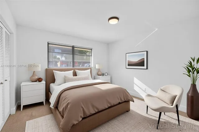 a bedroom with a bed and a large window