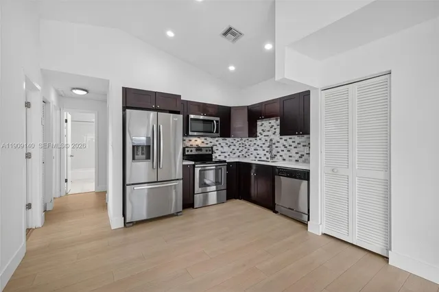 a kitchen with a refrigerator and a sink