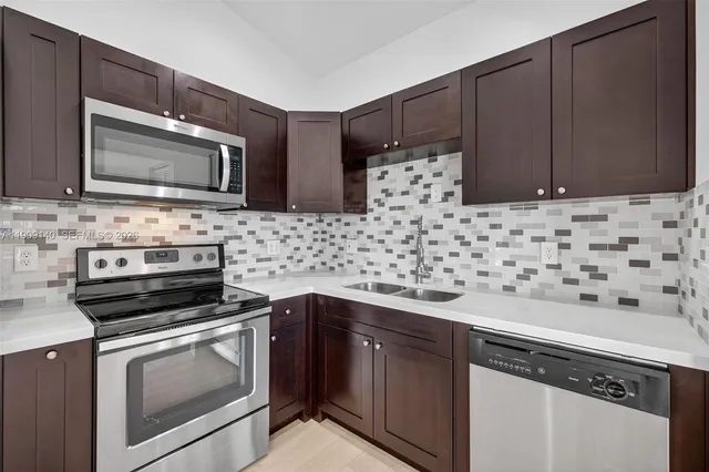 a kitchen with granite countertop cabinets and steel stainless steel appliances