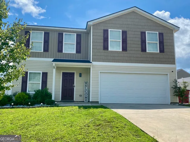 a front view of a house with a yard
