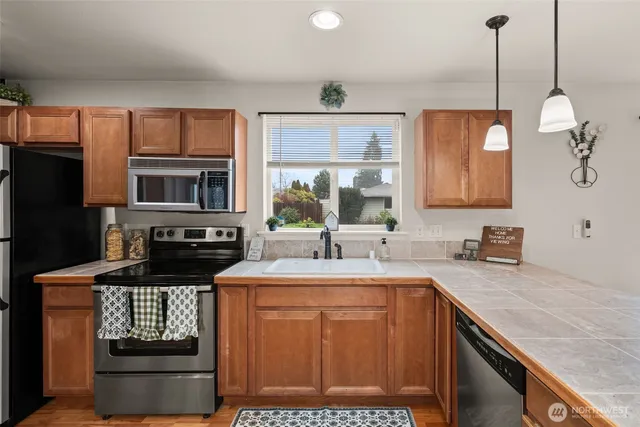 a kitchen with a sink stove and microwave
