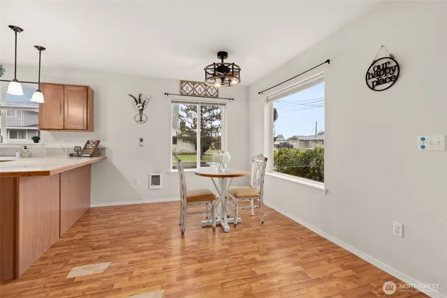 a view of a workspace with furniture and a window