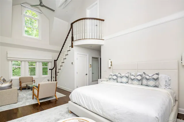 a bedroom with a bed a couch and dresser