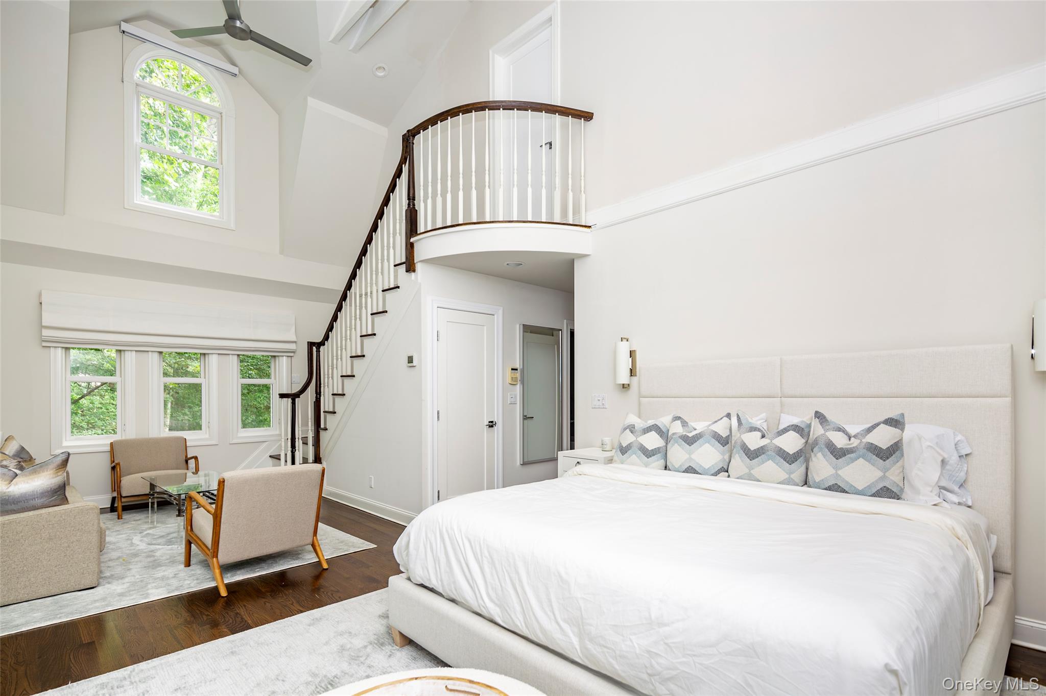 652 Noyac Path Water Mill, NY 11976 - Photo 16 of 41 Bedroom with multiple windows, high vaulted ceiling, wood finished floors, and baseboards