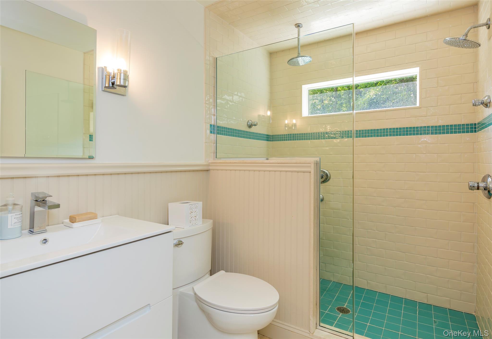 652 Noyac Path Water Mill, NY 11976 - Photo 19 of 41 Full bathroom featuring vanity, toilet, wainscoting, and a shower stall