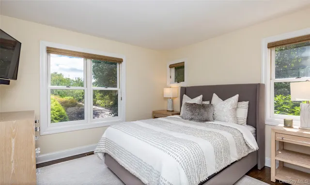 a bedroom with a large bed and a window