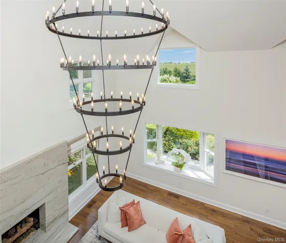 a room with a chandelier and pool table