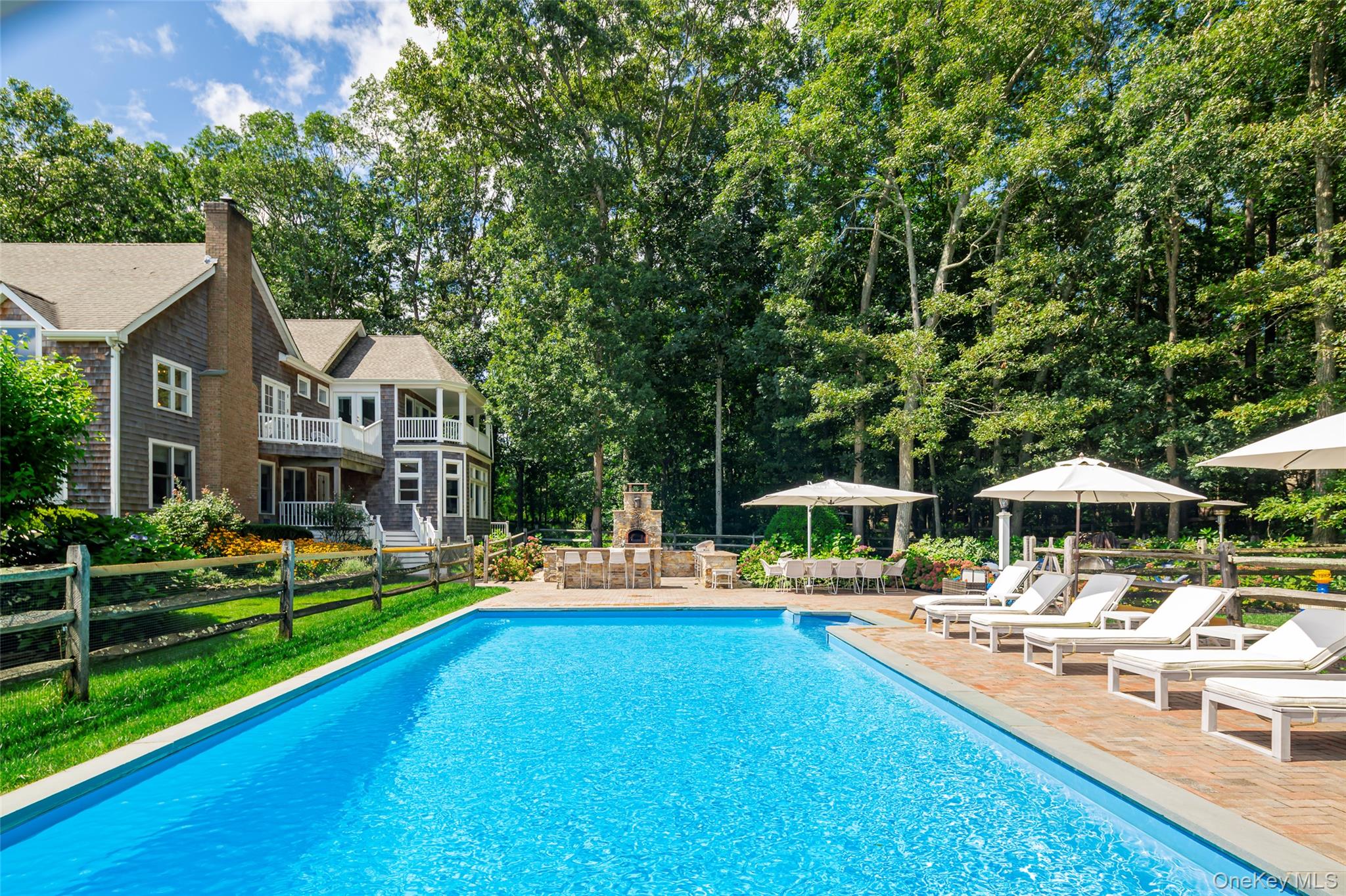652 Noyac Path Water Mill, NY 11976 - Photo 3 of 41 Outdoor pool featuring fence, a fireplace, and a patio area