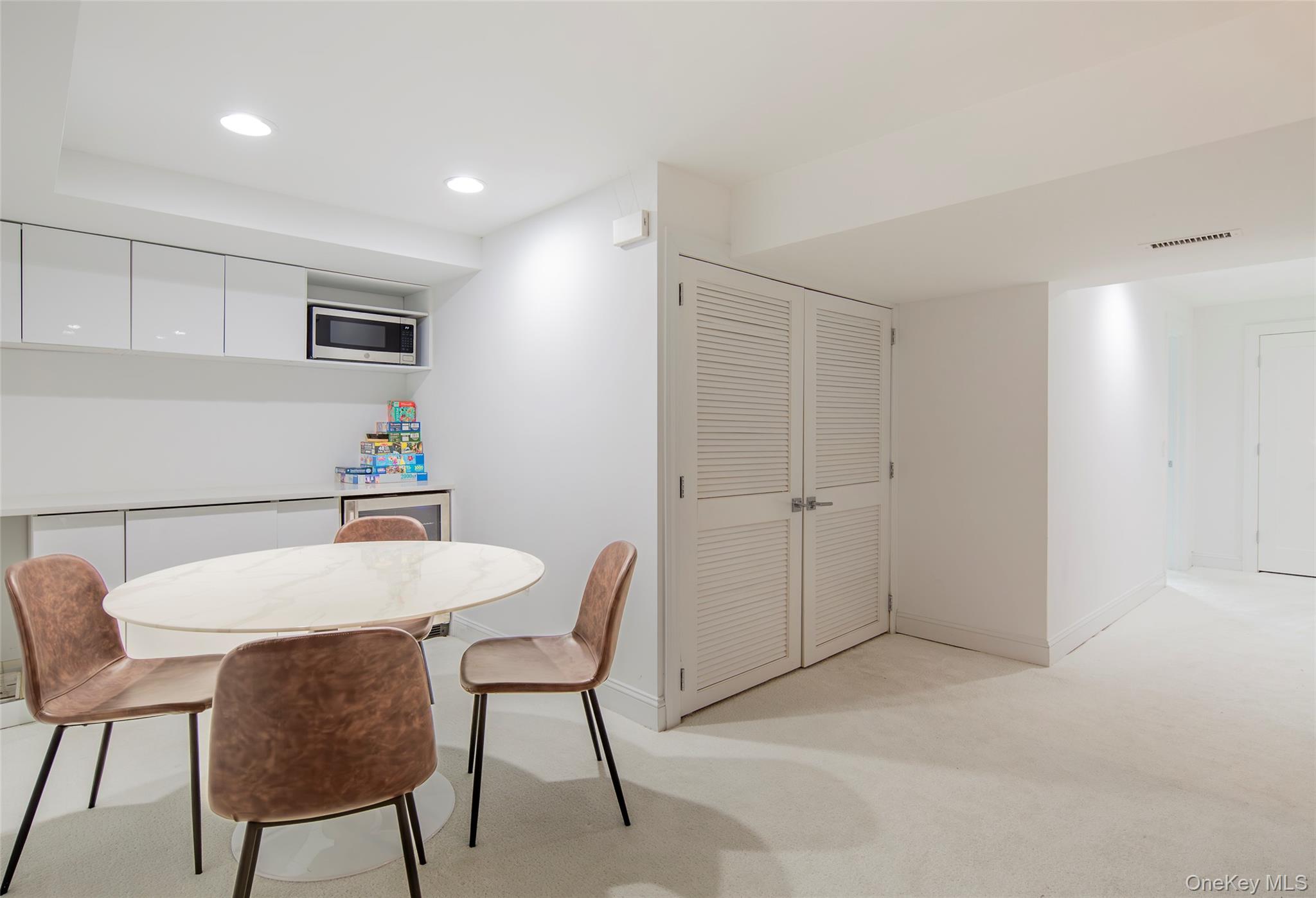652 Noyac Path Water Mill, NY 11976 - Photo 32 of 41 Dining space with baseboards, visible vents, recessed lighting, and light colored carpet