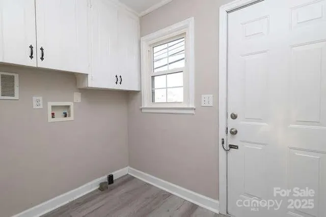 a room with a window and wooden floor