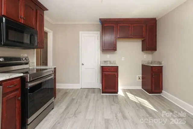 a kitchen with stainless steel appliances a refrigerator and a stove top oven