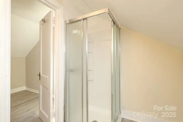 a bathroom with a glass shower door
