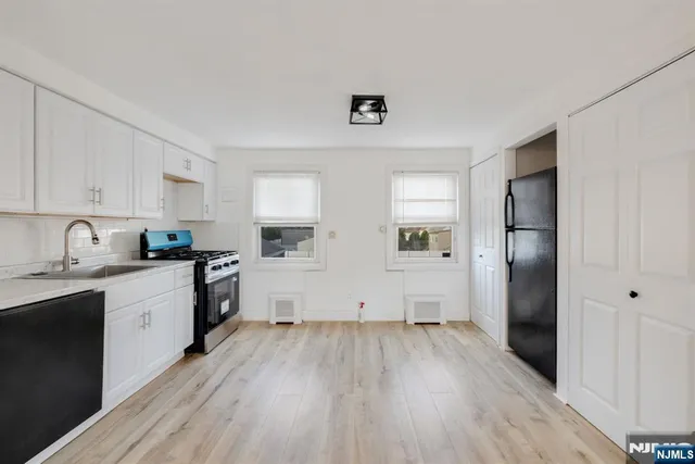 a kitchen with wooden floors and white appliances
