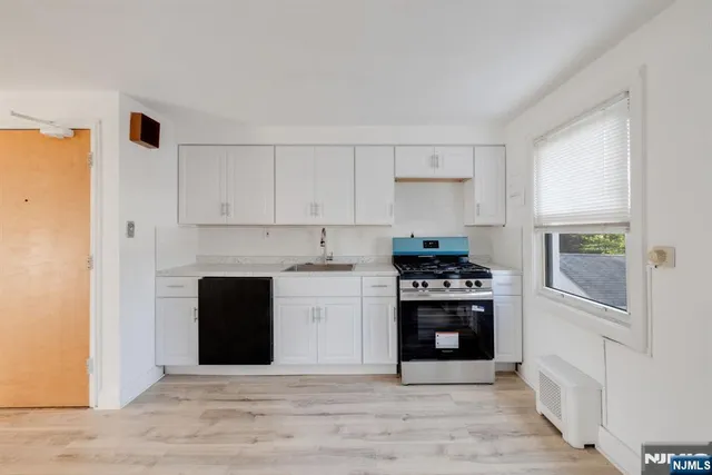 a kitchen with a stove and a refrigerator