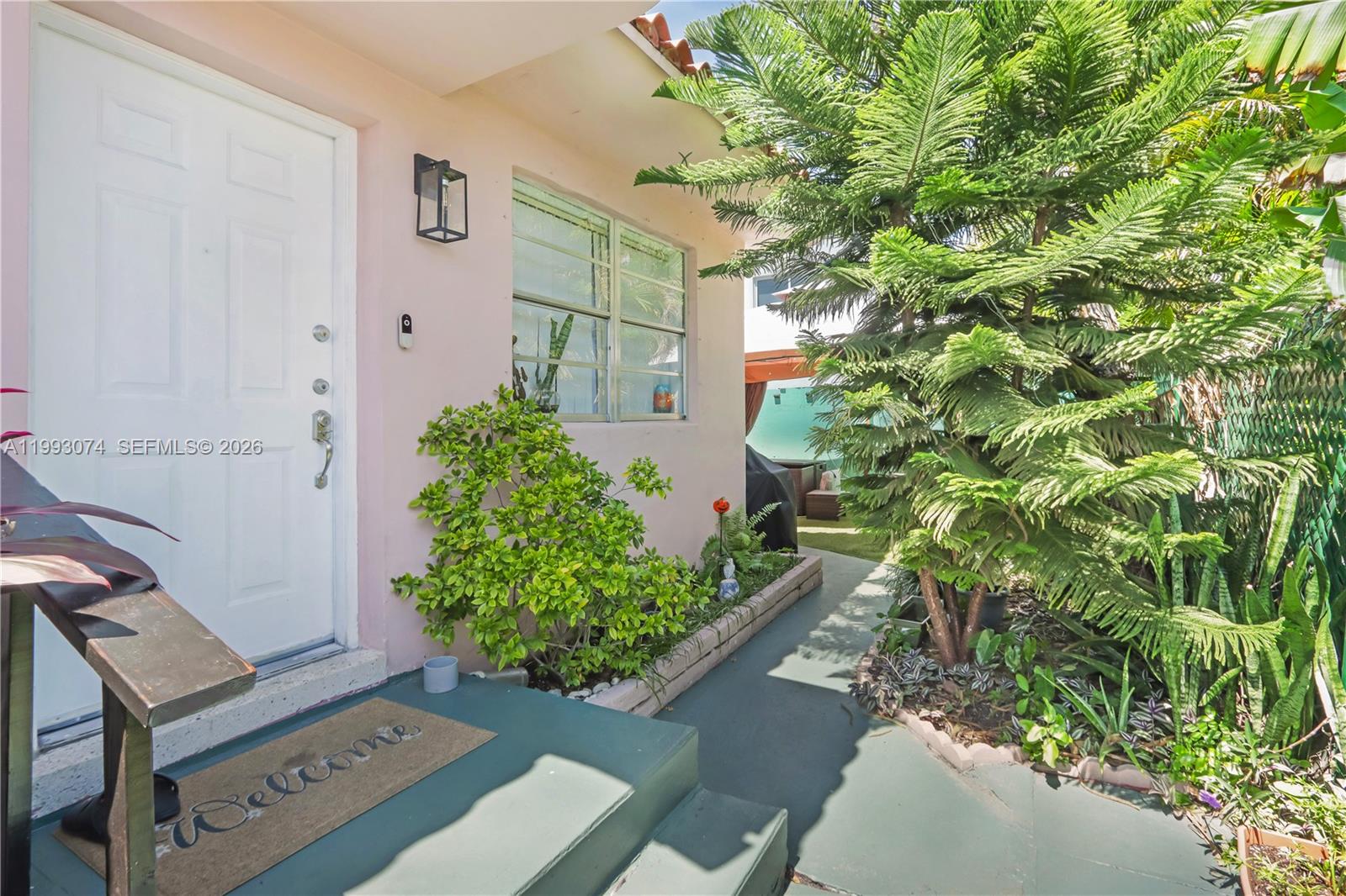 3675 Northwest 5th Street Miami, FL 33125 - Photo 2 of 8 view of a backyard with potted plants