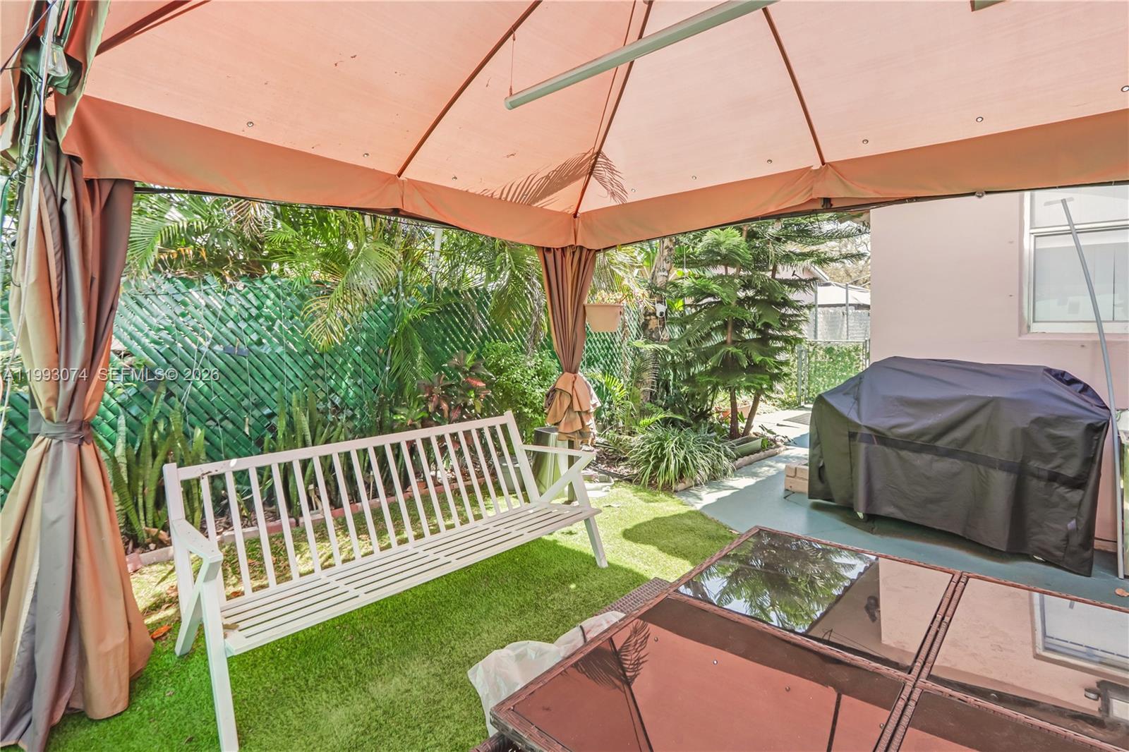 3675 Northwest 5th Street Miami, FL 33125 - Photo 3 of 8 a view of a chair and table in the garden