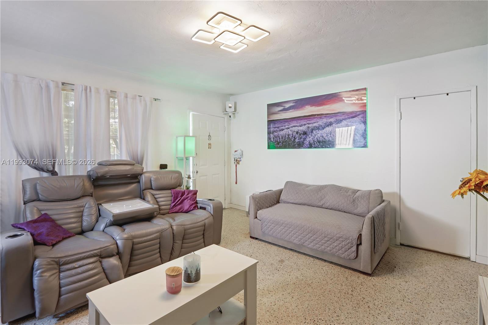 3675 Northwest 5th Street Miami, FL 33125 - Photo 5 of 8 a living room with furniture and a window