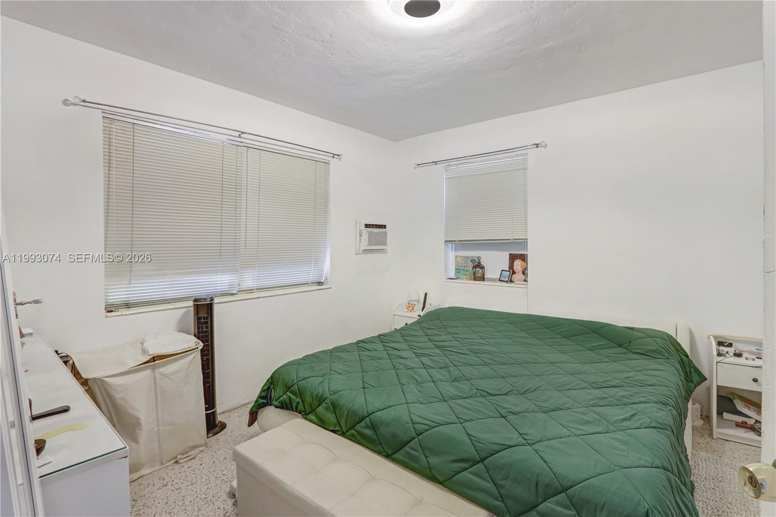 3675 Northwest 5th Street Miami, FL 33125 - Photo 6 of 8 a bedroom with a bed and a window