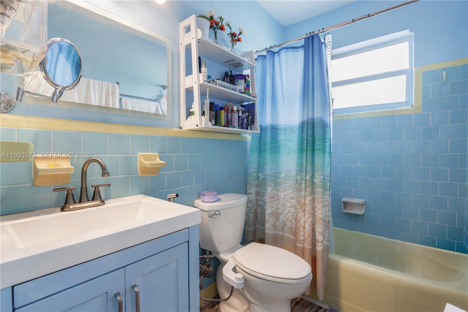 3675 Northwest 5th Street Miami, FL 33125 - Photo 7 of 8 a bathroom with a sink a toilet and shower curtain