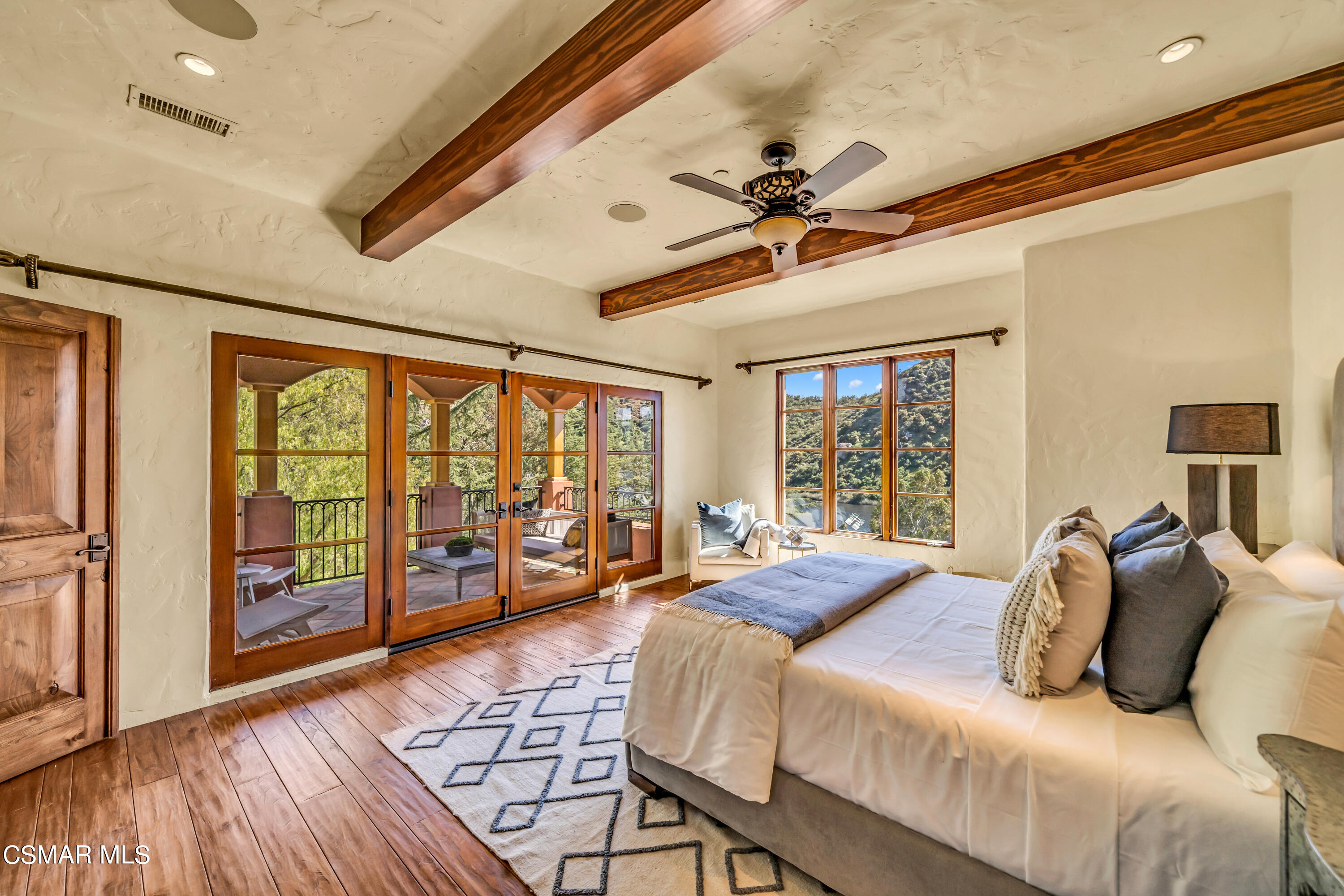1999 Trentham Road Lake Sherwood, CA 91361 - Photo 23 of 61 a bedroom with a large bed and a large window with wooden floor