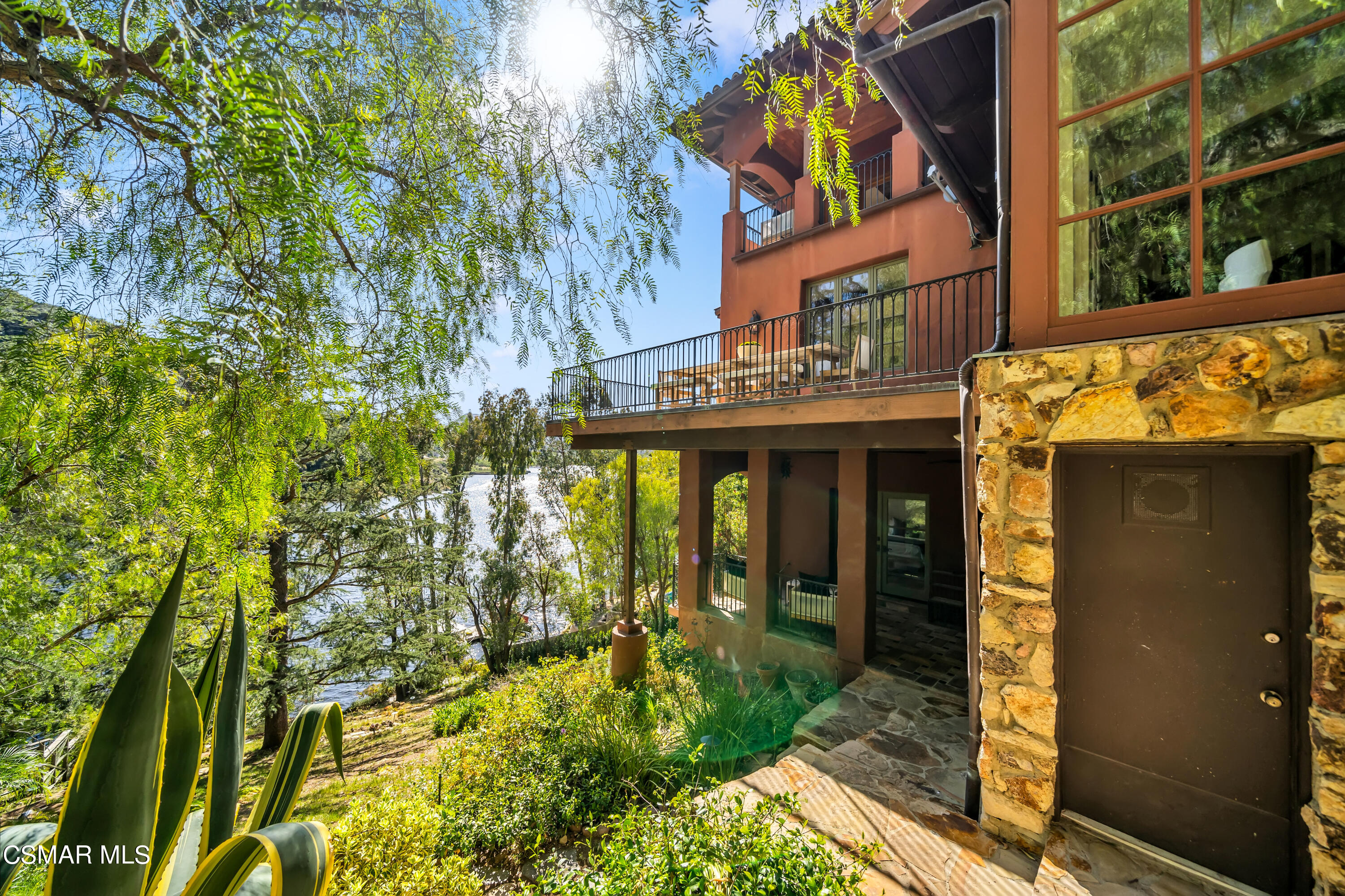 1999 Trentham Road Lake Sherwood, CA 91361 - Photo 40 of 61 a view of a brick house with a large tree and windows