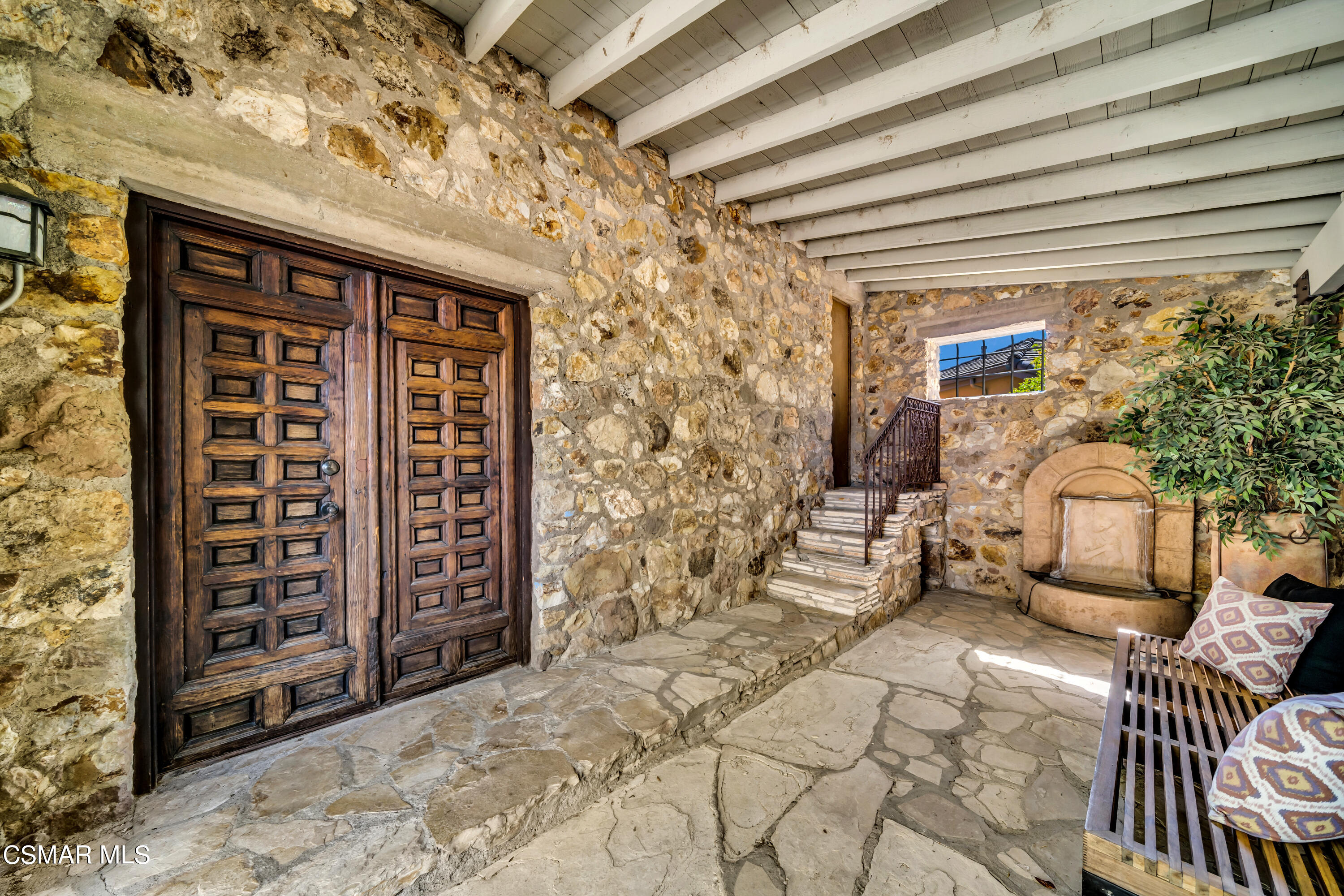 1999 Trentham Road Lake Sherwood, CA 91361 - Photo 41 of 61 a view of a porch with a table and chairs and potted plants