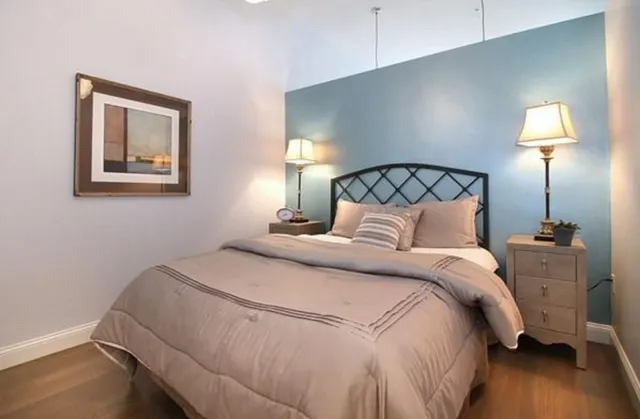 a bedroom with a bed and a night stand