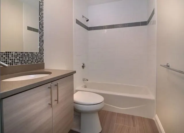 a bathroom with a sink toilet and shower
