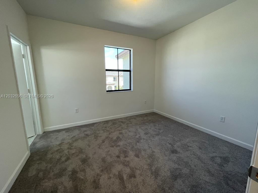 10144 Southwest 228th Terrace Miami, FL 33190 - Photo 13 of 23 an empty room with a window
