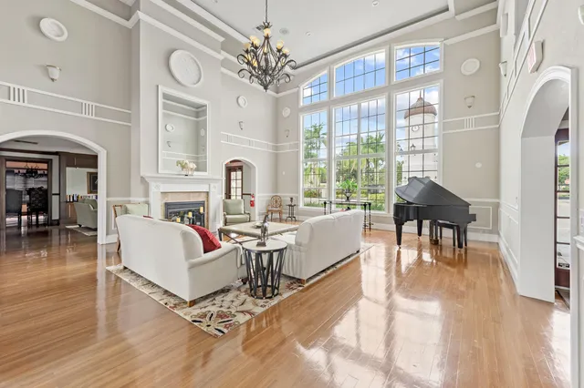 a living room with fireplace furniture and a large window