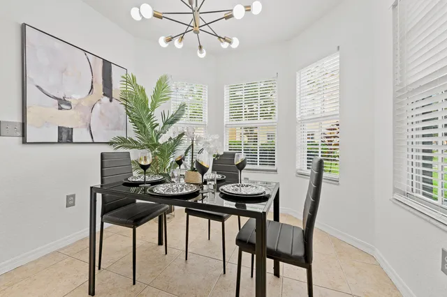 a view of a dining room with furniture and a potted plant