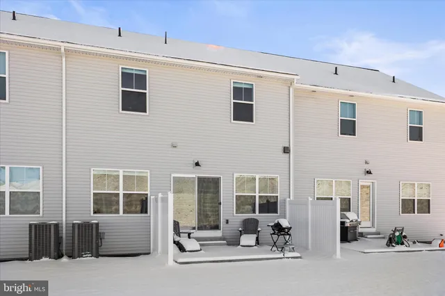 a building outdoor space with patio furniture and windows
