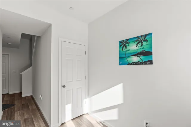 a view of hallway with wooden floor